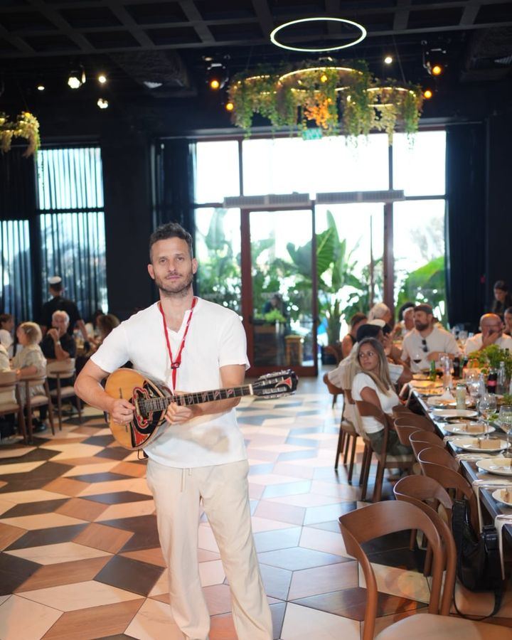 Bouzouki player at a restaurant event – Greek music for small events